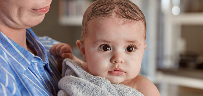Baby in towel after bath